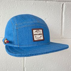 "Handmade cap with pencil holder✏️ ✎DETAILS: 5 panel cap is handmade from 10 oz indigo denim ( milled in the USA). Sewn with golden heavy duty top stitch thread. Patch, brim and hardware made in the USA. The brim is not a bought plastic insert. Brims are handmade here in house, they are shorter and softer than typical hats. They are super comfortable yet still completely hand washable and incredible durable. Hand built by two human makers ( apes/April & bird/Rich) with love, care and pride here Adjustable Denim Trucker Hat With Curved Brim, Adjustable Blue Denim Trucker Hat, Blue Adjustable Snapback Hat For Everyday, Casual Everyday Cap, Adjustable Denim Hat For Outdoor, Blue Adjustable Flat Cap Snapback Hat, Adjustable Blue Flat Cap Snapback Hat, Denim Cap For Outdoor Use, Denim Cap For Outdoor