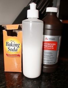 two bottles of baking soda sit on a counter next to a box of baking soap