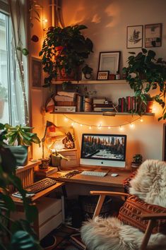 a desk with a computer and some plants on top of it in front of a window