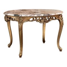 an ornately decorated table with marble top