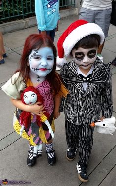 two children dressed up in halloween costumes and make up as jack and sally the cat