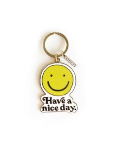 a smiley face keychain with the words have a nice day written on it