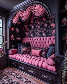 a pink couch sitting in front of a window