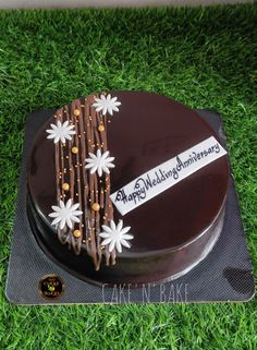 a chocolate cake with white flowers on it