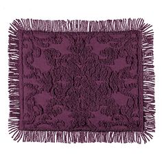 a purple rug with fringes on the bottom and an intricate design in the middle