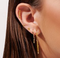 This enchanting helix features a delicate lotus design set with vibrant natural yellow diamonds on a solid gold base. Perfectly complements any ear stack with its effortless elegance and radiant sparkle. Yellow Gold Ear Climbers Fine Jewelry, Yellow Gold Fine Jewelry Ear Climbers, Gold Cubic Zirconia Ear Climbers Fine Jewelry, 14k Yellow Gold Ear Climbers With Diamond Accents, Yellow Gold 14k Diamond Accented Ear Climbers, Yellow Gold Ear Climbers In Fine Jewelry Style, Yellow Gold Diamond Ear Climbers For Gift, Single Yellow Gold Cubic Zirconia Ear Climber, Diamond Gold Ear Climbers As Gift