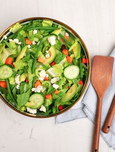 a salad with cucumbers, carrots and feta cheese in a bowl