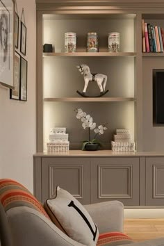 a living room filled with furniture and bookshelves