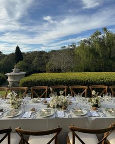 a table set up for a formal dinner outdoors