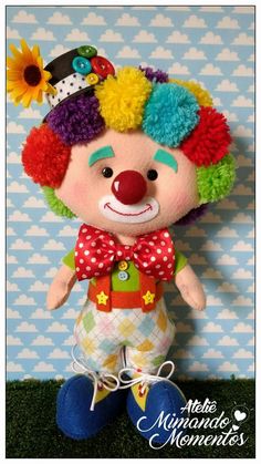 a stuffed toy clown with colorful hair and makeup