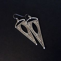 Silver plated, embossed, triangle shaped earrings - Silver plated, embossed Zamak triangle shaped dangles - from EU - Niobium and Sterling silver ear wires - Top of ear wire to bottom of dangle measures 3-in - Side to side at widest point of dangle measures approximately 1-in - Clear rubber stoppers included *These earrings are so beautiful and super lightweight! Bohemian Triangle Nickel-free Earrings, Nickel Free Triangle Metal Earrings, Nickel-free Metal Triangle Earrings, Etched Metal Drop Earrings, Etched Metal Dangle Earrings, Jewelry Silver Earrings, Jewelry Chunky, Silver Diamond Necklace, Dangle Belly Rings