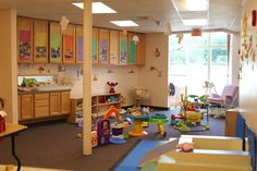 a child's playroom with lots of toys on the floor and in the wall