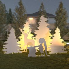 a paper cut out of a girl and deer in front of a house at night