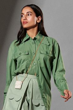 Fern green oversized shirt with scalloped collars patched pockets and front buttons.
Component: 1
Pattern: Plain
Neckline: Collar
Sleeve Type: Cuff Hem Sleeves
Fabric: 80% Polyester, 20% Cotton
Color: Green
Other Details: 
Scalloped hem collar
Oversized silhouette
Front button down
Note: The skirt and sling bag worn by the model is not for sale
Occasion: Party, Work - Aza Fashions Green Workwear Tops With Flap Pockets, Green Tops With Flap Pockets For Work, Green Shirt With Casual Collar And Pockets, Green Shirt With Pockets And Casual Collar, Classic Green Shirt With Pockets, Green Tops With Pockets, Trendy Shirt With Lapel Collar And Pockets, Green Collared Shirt Solid Color, Green Collared Shirt With Solid Color