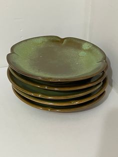 four green plates stacked on top of each other