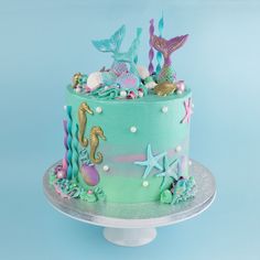 there is a cake decorated with seahorses and starfish on the top tier