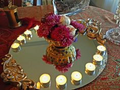 a tray with candles and flowers on it