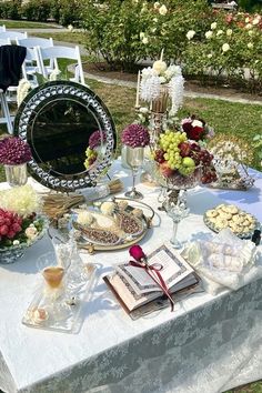 a table topped with lots of different types of food and wine glasses on top of it