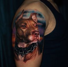 a man with a tattoo on his arm has a dog's face painted on it