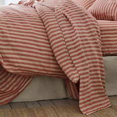 a bed with red and white striped sheets