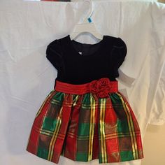 Bonnie Baby Girls Christmas Holiday Dress New With Tags Toddler Baby Dress Red, Green, And Gold Plaid Skirt With Red Decorative Bow And Black Bodice. 24 Months. Bonnie Jean's Signature Christmas Dress. Classic Red, Gold, And Green Plaid With A Stretch Black Velvet Bodice And Ribbon Flower At Waist. Has Attached Red Petticoat And Matching Red Panties Or Diaper Covers.Style: Hope Matching Sister Dress: Available In All Size Ranges Polyester, Spandex, Metallic Machine Wash Cold, Gentle Cycle Origin Cute Fitted Christmas Holiday Dress, Festive Short Sleeve Holiday Dress For Christmas, Festive Holiday Dress With Short Sleeves, Festive Short Sleeve Holiday Dress, Red Christmas Playtime Dress, Green Christmas Dress Toddler, Toddler Christmas Dress Green, Vintage Toddler Christmas Dress, Red Baby Dress