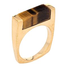 This is part of Chairish’s Fine Jewelry assortment.  Stylish vintage square stacking ring (circa 1970s to 1980s) crafted in 14 karat yellow gold.  The band is inlaid with tigers eye measuring 5mm wide (few tiny nibbles to the tigers eye visible under a 10x loupe).  The striking square ring features luminous tigers eye inlaid into the band. The ring is great worn alone or layered with your fine jewellery from any era. The low rise band (7mm - 0.27 inches) sits comfortably on the finger.    The ri Modernist Gold Rectangular Signet Ring, Gold Rectangular Modernist Signet Ring, Modern Brown Rings For Anniversary, Modern Brown Anniversary Ring, Stacking Bands, Square Ring, Square Rings, Gold Geometric, Late 20th Century