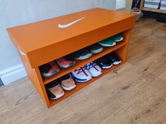 an orange shoe rack with several pairs of shoes on it