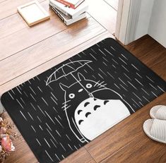 a door mat with an image of a totoro holding an umbrella in the rain