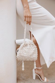 Hand beaded bridal clutch with beaded tassels. 9 inches wide by 9 inches tall with adjustable ties for easy closure SHIPPING TIME IN STOCK AND READY TO SHIP - Ships in 1 - 3 business days Cream Woven Evening Bag, Chic Beaded Wedding Bags, Rectangular Wedding Clutch With Tassels, Chic Clutch With Tassels, Elegant White Bags With Tassels, Elegant Evening Clutch With Tassels, Elegant Evening Bag With Fringe, Elegant Fringe Bags For Wedding, Elegant Fringed Bags For Wedding