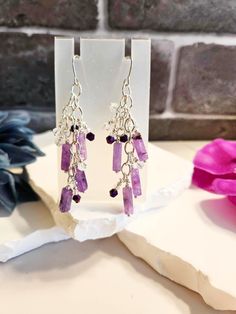 "These are handmade earrings with amethyst gemstones, silver findings and various other beads. Sterling silver earring hooks. These measure about 3\" top to bottom." Purple Crystal Drop Earrings With Dangling Beads, Amethyst Dangle Earrings For Jewelry Making, Silver Amethyst Dangle Earrings, Silver Amethyst Dangle Crystal Earrings, Purple Crystal Dangle Earrings With Beads, Purple Sterling Silver Beaded Dangle Earrings, Silver Amethyst Crystal Earrings With Ear Wire, Handmade Purple Amethyst Chandelier Earrings, Handmade Amethyst Dangle Crystal Earrings