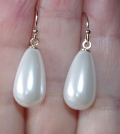 Being offered is a fabulous 14K GOLD FILLED WHITE 30MM TEAR DROP WHITE COATED JAPANESE PEARL EARRINGS  THESE PEARLS ARE NEW OLD STOCK PEARLS MADE IN JAPAN IN 1950'S  THESE OLD STOCK PEARLS  HAVE INCREDIBLE LUSTER AND ARE MEDIUM SIZE  EARRINGS COATED JAPANESE PEARLS ARE FAMOUS MAN MADE PEARLS / QUALITY AND LUSTER THEY ARE NEW OLD STOCK FROM HOBE COMPANY. I HAVE FEW PAIRS.  PLESAE SEE PHOTOS. QUALITY PEARL TEAR DROPS. THE WHOLE EARRINGS DROPS ARE 30 MM/ 1.20 INCHES /  2.1 GRAMS INCREDIBLE LUSTER AND SHINE / 14K SOLID GOLD EAR WIRES  IF YOU WANT SOMETHING LARGE AND YET WEIGHT LIGHT, THESE ARE FOR YOU. YOU WILL LOVE WEARING THEM.Privacy policy, return policy; If you are returning the merchant just because you did not like it, you will have to pay for return ship. option 1 ; you can either have Classic White Teardrop Earrings For Wedding, White Teardrop Pearl Earrings For Party, Classic White Drop Earrings, White Drop Teardrop Earrings For Party, White Teardrop Earrings For Party, White Pear-shaped Party Jewelry, Classic White Pearl Earrings For Party, White Drop Pearl Earrings For Party, Elegant White Teardrop Earrings For Gift