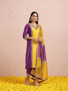 Featuring a plum and golden yellow colourblockchanderi kurta set with gota and hand embroidery. It is paired with pants and a colourblock silk organza dupatta. Color: Golden Yellow and Plum Fabric: Chanderi Note: The product will be shipped within 30-35 days of order placed Wash care - Dry Clean Only. Do not use heavy Iron Yellow And Purple Outfit Indian, Unstitched Purple Suit With Dupatta, Elegant Purple Kurta With Sheer Dupatta, Elegant Yellow Embroidered Dupatta, Yellow Mulmul Set With Dupatta, Canada Punjabi, Mustard Colour Combination, Golden Yellow Dress, Plum Fabric