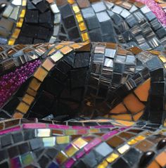 many different colored mosaic tiles are arranged together