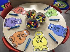 children's play table with bears and crayons on it