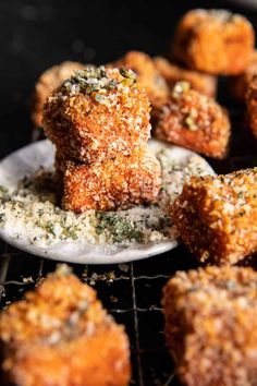 some fried food is sitting on a plate and it's ready to be eaten