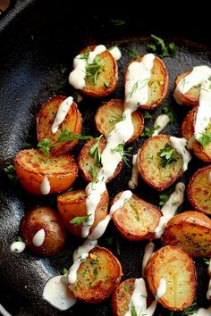 crispy potatoes with vegan ranch dressing in a cast iron skillet, ready to be eaten