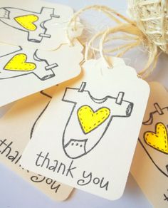 three tags with thank you written on them sitting next to a twine of twine