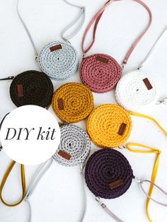 several crocheted purses are arranged on a white surface with the words dry kit written across them