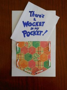 there's a wocket in my pocket greeting card on a wooden table