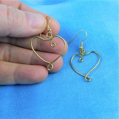 Non tarnish brass wire is sculpted by hand using only pliers, into two unique hearts, measuring 1 inch in each direction and suspended from brass ear wires. These fun earrings are light weight and easy to wear. They would be a great gift for Valentine's Day, special occasion, or any occasion. Your special earrings are ready to ship via USPS to your US location at no extra cost. (International shipping also available. Please be aware of your local laws related to customs and VAT.) Special Earrings, Presents For Girlfriend, Art Romantic, Wearable Art Jewelry, Presents For Women, Heart Dangle Earrings, Custom Earrings, Valentines Jewelry, Fun Earrings