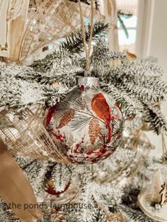 an ornament hanging from the top of a christmas tree