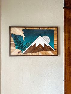 a painting hanging on the side of a wall next to a wooden door and window