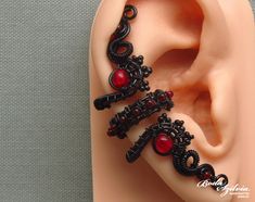 Adjustable wire wrapped gothic ear cuff, no piercig required! It's made of black artistic wire, seed beads and red glass beads. It looks great on both the left and right ear. Available: - single piece - pair Plz, select from the list (select style). Made for order. I'll need 1-5 days to make your ear cuff. Please note that each one is made 100% by hand and may vary a little from the photo. You can find more ear cuffs here: https://www.etsy.com/shop/bodaszilvia?section_id=10952870&ref=shopsection Red Ear Piercings, Bohemian Black Jewelry With Internally Threaded Details, Gothic Black Ear Cuff Single Earring, Handmade Adjustable Gothic Ear Cuff, Handmade Black Ear Cuff, Handmade Adjustable Black Ear Cuff, Gothic Black Single Ear Cuff, Handmade Black Gothic Body Jewelry, Handmade Gothic Black Body Jewelry