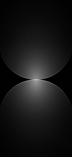 an abstract black and white photo with light coming from the center, reflecting on the surface