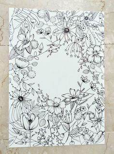 a white paper with black and white flowers in the center on a marble surface,