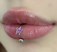 a close up view of a woman's lip with a nose piercing