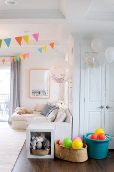 a living room filled with furniture and balloons