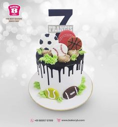 a sports themed birthday cake with the number seven on top and balls in the middle