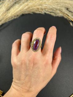 Vintage Amethyst Ring 9ct Gold Stamped Hallmarked London 1966 Makers Mark H.B Introducing a stunning vintage cocktail ring that is sure to impress! This piece features a fabulous oval faceted amethyst at its centre, surrounded by a border of beautiful natural seed pearls. The large size of the amethyst makes a bold statement, while the delicate pearls add a touch of elegance to the ring. The yellow gold shank is designed with fancy shoulders, adding to the overall charm and character of this piece. The ring is in great condition and will make a perfect addition to any jewellery collection.   The ring measures approximately 24mm in height & 15.5mm in width. UK Size O US Size 7 1/2 This ring can be resized using our resizing service, please contact us to discuss this before purchase.   All o Vintage Ruby Ring With Accent Stones For Formal Occasions, Vintage Amethyst Ring With Accent Stones, Vintage Ruby Ring In Yellow Gold With Accent Stones, Vintage Yellow Gold Ruby Ring With Accent Stones, Vintage Amethyst Ring With Accent Stones For Collectors, Oval Ruby Ring For Party, Oval Ruby Ring For Parties, Purple Oval Rings For Party, Purple Oval Party Rings