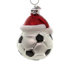 a soccer ball ornament with a santa hat on it